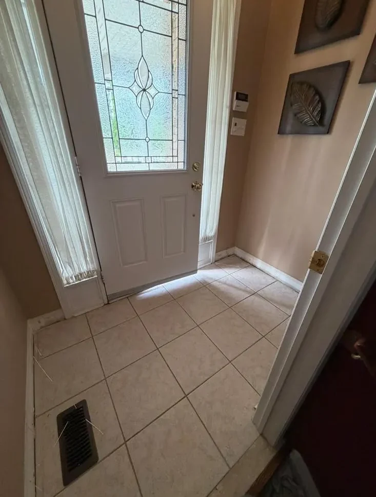 Hardwood staircase landing before renovation
