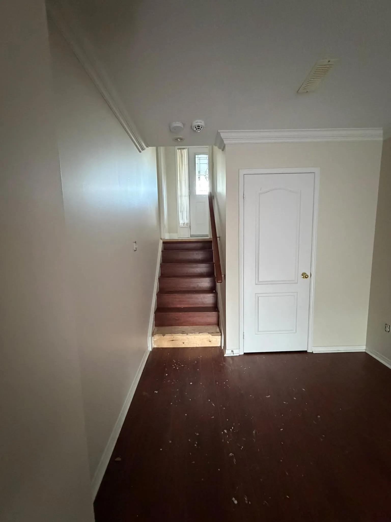 Hardwood staircase landing before renovation